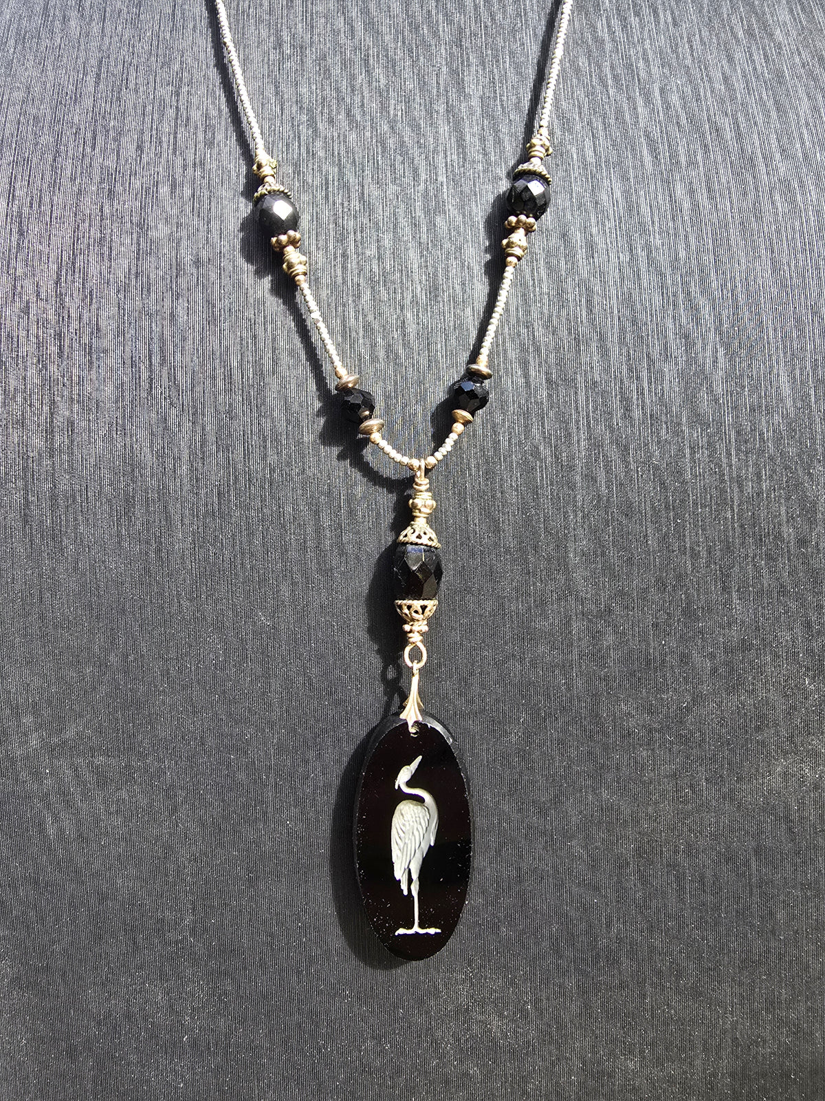 Antique crane intaglio made from stunning black glass on long metallic bead and black glass chain