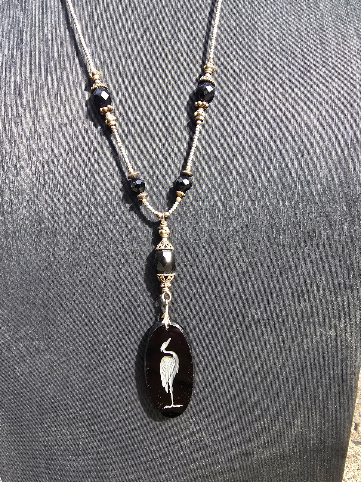 Antique crane intaglio made from stunning black glass on long metallic bead and black glass chain