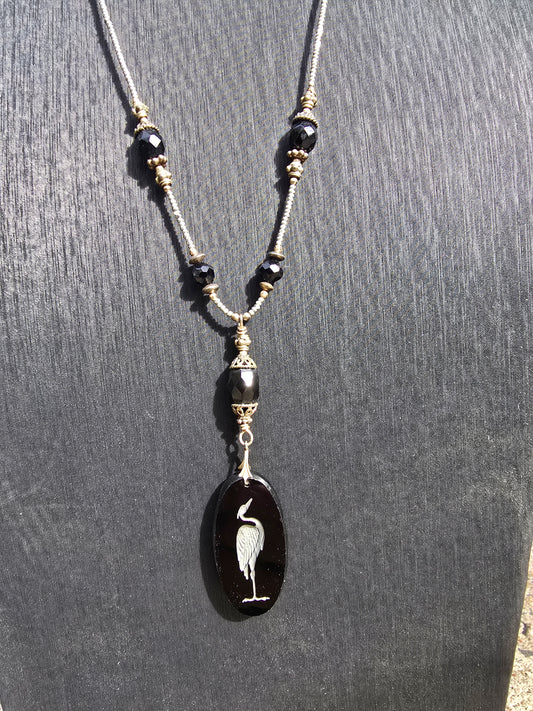 Antique crane intaglio made from stunning black glass on long metallic bead and black glass chain